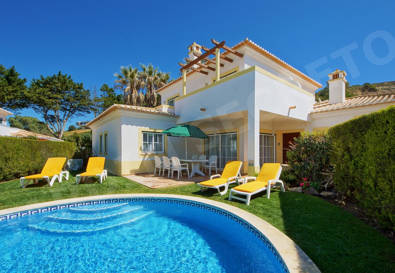 Private swimming pool with yellow sun loungers at Jardim Secreto villa in Carvoeiro Algarve